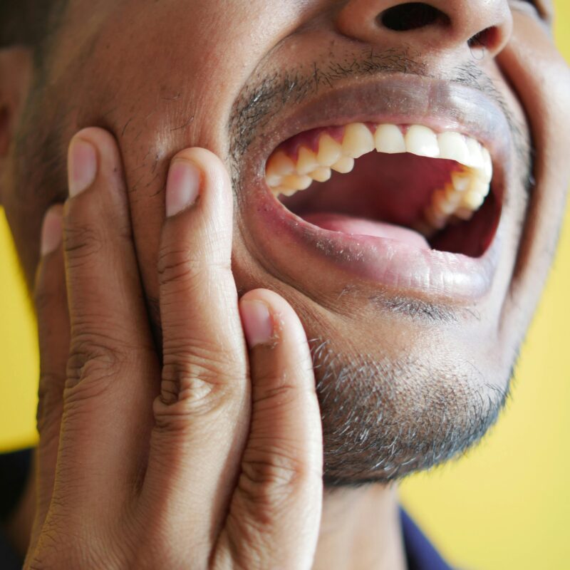 A man with dental implants smiling.